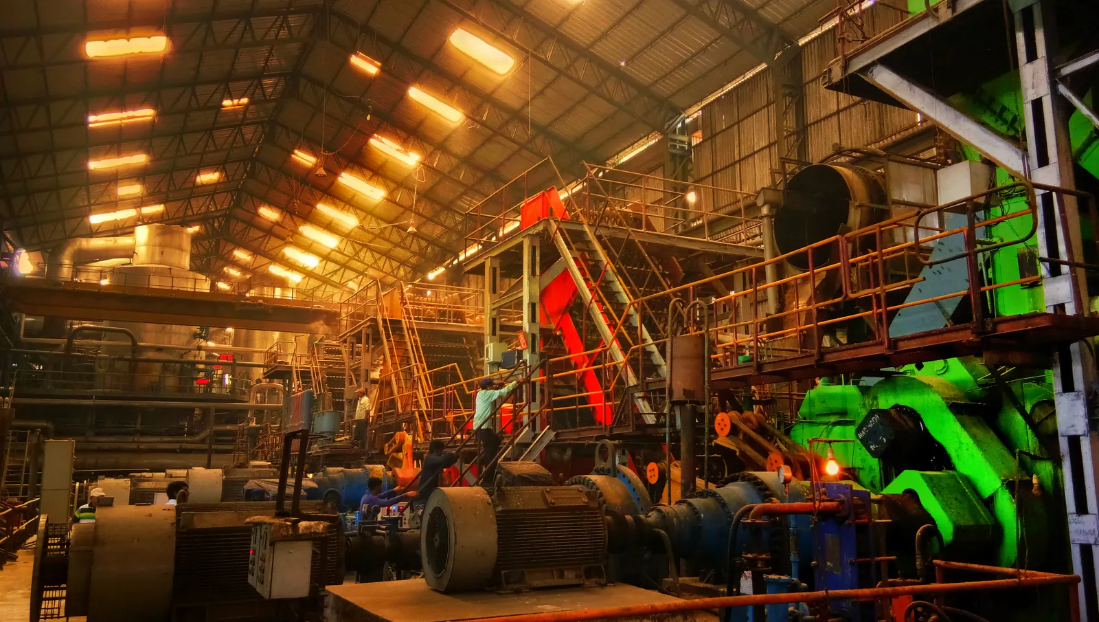 Interior of a large heavy-engineering factory with machinery and overhead cranes in Ahmedabad